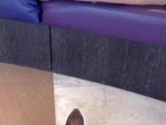 A girl slips off her heels from tired stocking-clad legs and sinks into the couch... relief at last